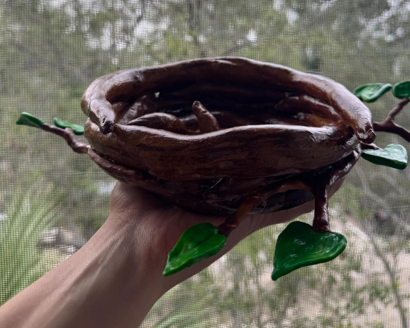 "Happy mother holding her baby daughter while smiling outdoors — symbolizing family health and protection."